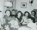 Adrian Scott socializing with Norma Barzman, Jeannie Lees, Bobby Lees, and Anne Shirley (seated on floor), c. 1946.