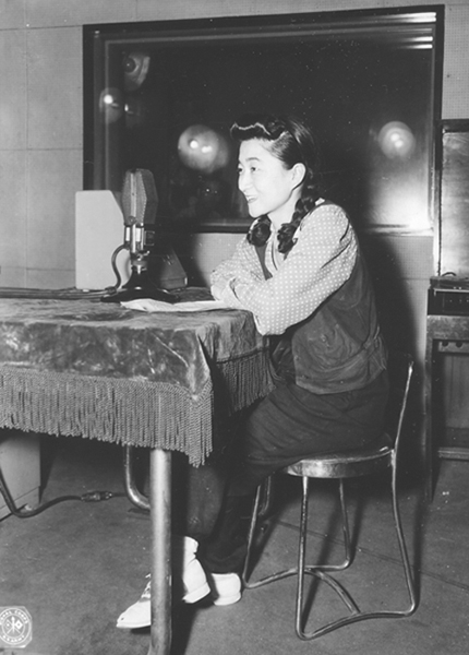 Iva Toguri photographed before the microphone at Radio Tokyo in September 1945.